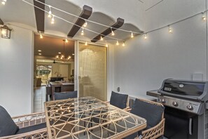 Outdoor Dining & BBQ – Enjoy alfresco meals with a grill and cozy seating under string lights.
