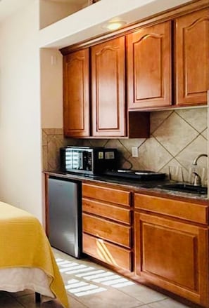 Mini frig, microwave, burners, garbage disposal, pans, glasses, plates, utensils