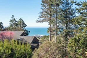 Deck with out door seating, grill and partial ocean view 