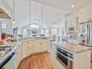 Stunning gourmet kitchen with granite countertops, high-end appliances, and a spacious island for meal prep.
