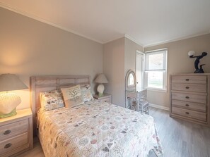 Inviting bedroom featuring elegant decor, a comfortable double bed, and plenty of natural light.
