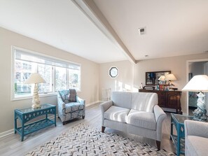 The beautifully arranged living space offers a bright and airy feel, perfect for relaxation after a day at the beach.