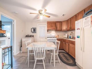The cozy kitchen features new flooring and a welcoming dining area, making meal prep a breeze.
