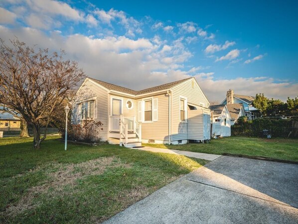 This charming beach cottage features freshly painted exteriors, new flooring, and ample yard space, providing a cozy retreat just moments from the shoreline.