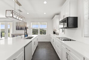 Cook for the whole crew in this fully stocked chef’s kitchen featuring stainless steel appliances, a large island, and plenty of space for group meals.