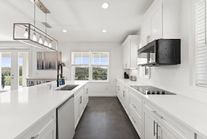 Cook for the whole crew in this fully stocked chef’s kitchen featuring stainless steel appliances, a large island, and plenty of space for group meals.