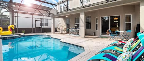 Orlando villa lanai with heated pool, loungers & bistro—relax in style.