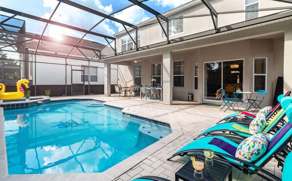 Orlando villa lanai with heated pool, loungers & bistro—relax in style.