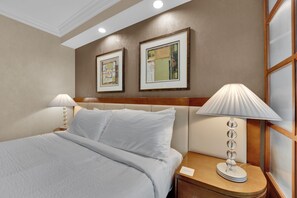 A lavish, cloud-like king-size bed dressed in high-thread-count linens, inviting you to sink into blissful relaxation.