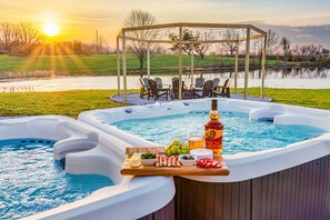 Dip into relaxation while you snack like royalty—because cheese and crackers taste better with jets and a view.