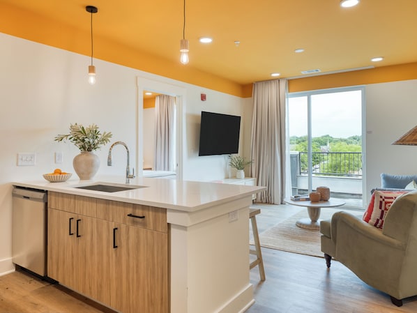 Fully equipped kitchen and sunny living area.
