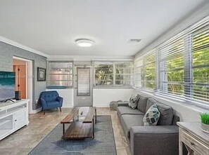 An open-concept living space with large windows, abundant natural light, and elegant finishes.