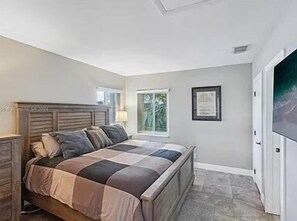 A bright and airy second bedroom with generous closet space, perfect for guests or a home office.