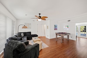 Make the most of your downtime in the spacious living room, where fun and comfort meet. A classic soccer table takes center stage, perfect for friendly matches and hours of entertainment.