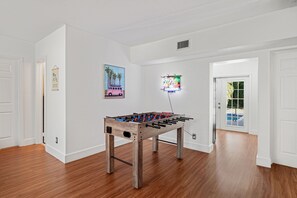 Make the most of your downtime in the spacious living room, where fun and comfort meet. A classic soccer table takes center stage, perfect for friendly matches and hours of entertainment. 