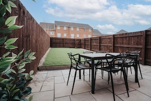 Enjoy al fresco dining in this beautiful outdoor space, perfect for hosting meals and relaxing in the fresh air.