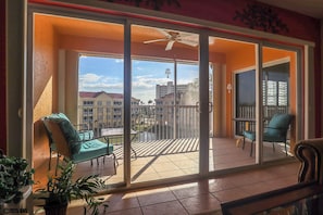 Large Glass Doors open up the living space to the Screened In Lanai