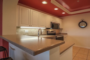 Large Kitchen enjoys corian countertops, new appliances and comes fully equipped with cookware and tableware