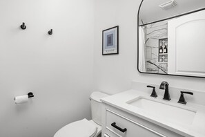 This modern bathroom combines sleek design with functional convenience.