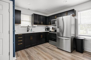 This kitchen is equipped with high-end appliances and features clean lines, complemented by elegant finishes that enhance its contemporary feel.