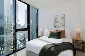 Second Bedroom with City Views, blinds and built in mirrored robes 