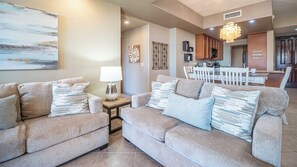 Living room backed by the dining kitchen and table.