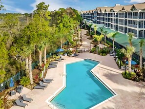 Stunning Aerial View Of The Resort-Style Community With A Large Pool And Lush Landscaping