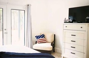 King bedroom with french glass doors that lead out to the porch area. 