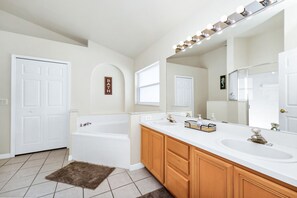 Modern bathroom with sleek finishes and a spacious shower for your comfort.