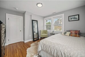 Spacious closet and a dresser for storage, along with a large smart TV