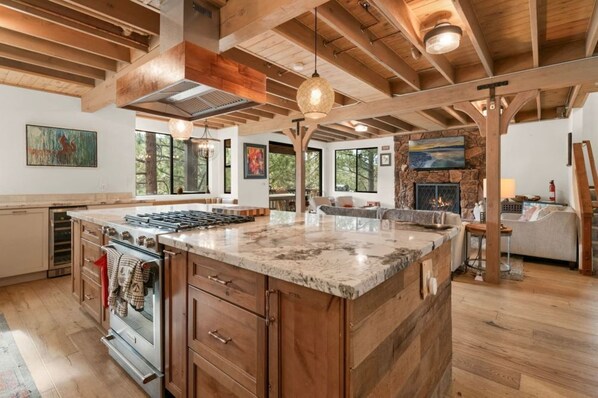 "Gather in our spacious kitchen and living area, where modern elegance meets rustic charm under exposed beams.