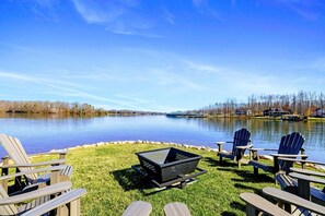 Gather around the spacious lakeside fire pit area with plenty of Adirondack seating, perfect for cozy evenings and unforgettable waterfront memories.