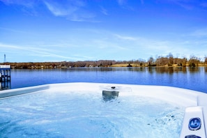 Unwind in the lakeside hot tub while soaking in panoramic views of the tranquil lake and lush surroundings.
