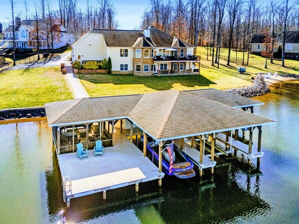 Relax in this expansive lakefront retreat with a private dock, multiple balconies, and ample outdoor space to unwind and take in the beauty of Lake Anna.