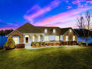 Experience serene lakefront living in this spacious, beautifully designed home featuring stunning water views and elegant charm.