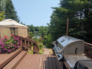 Deck off of cottage with views of the lake