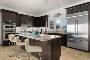 Create delicious meals in the fully stocked chef’s kitchen, complete with high-end appliances, granite countertops, and a spacious breakfast bar. Whether you're preparing a quick snack or a gourmet feast, this kitchen has everything you need.