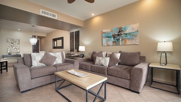Elegant living room with two sofas, TV.
