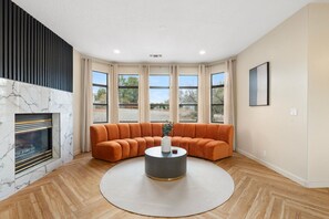Stylish and cozy living space with a fireplace and scenic views.