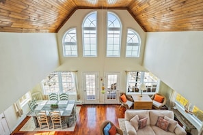 This airy, sunlit space features high ceilings, rustic charm, and a seamless indoor-outdoor flow to a spacious deck. Ideal for gatherings and relaxation! "Lake House"