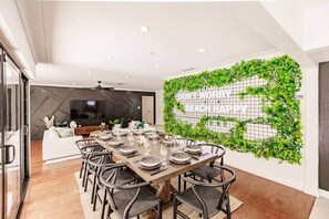 Dining table for 10 with wonderful pool views with the floor to ceiling glass doors.