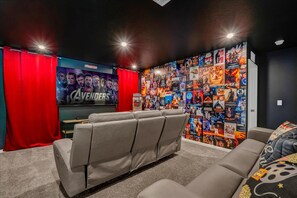 Immerse yourself in a cinematic experience in this private home theater, complete with plush recliners and a captivating movie poster wall.
