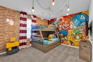 Dive into adventure in this vibrant themed room with bunk beds and playful decor, perfect for young gamers!