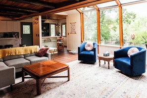 Living room, couch, TV, chairs with views of the lake