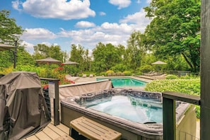 Hot tub and pool, nestled in a serene natural setting