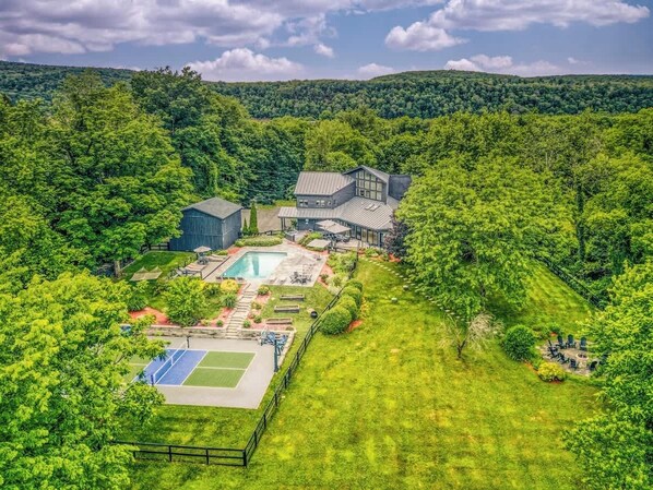 Aerial view of the home and surrounding natural landscape
