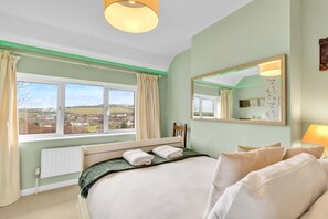 Serene countryside views from the bedroom window, ideal for a relaxing getaway