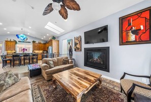Inviting main living room featuring a smart TV & access to a balcony
