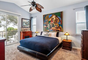Serene king ensuite bedroom featuring a private balcony with ocean views