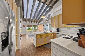 Spacious kitchen with modern appliances, ideal for preparing fresh island-inspired meals.